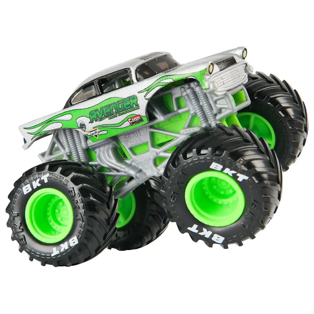 Monster Jam Avenger monster truck side view shows metallic silver paint, green flame graphics, tubular frame detailing, oversized treaded tires, and lifted stance, capturing the iconic Avenger look in a collectible 1:64 scale model.