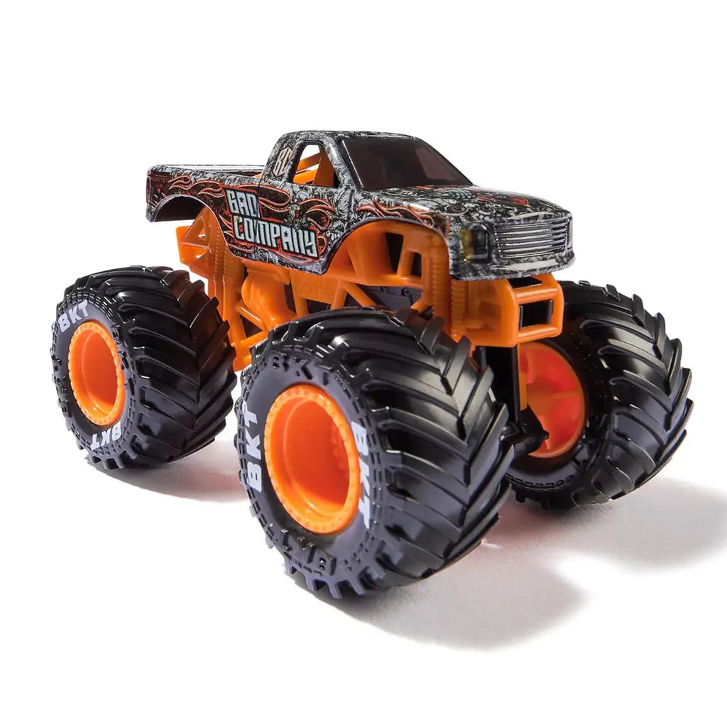 Monster Jam Bad Company 1:64 scale diecast monster truck featuring rugged black, gray, and white patterned body, orange frame, and large black tires with orange hubs.