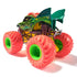 Rear angled view of Monster Jam Dragon diecast truck at 1:64 scale, featuring detailed dragon artwork, bright red treaded wheels, and yellow-green chassis details.