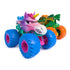 colorful monster truck toy Monster Jam Sparkle Smash, glossy plastic body in pink, purple, and blue with unicorn horn and sculpted face, oversized textured wheels, displayed on a clean white background