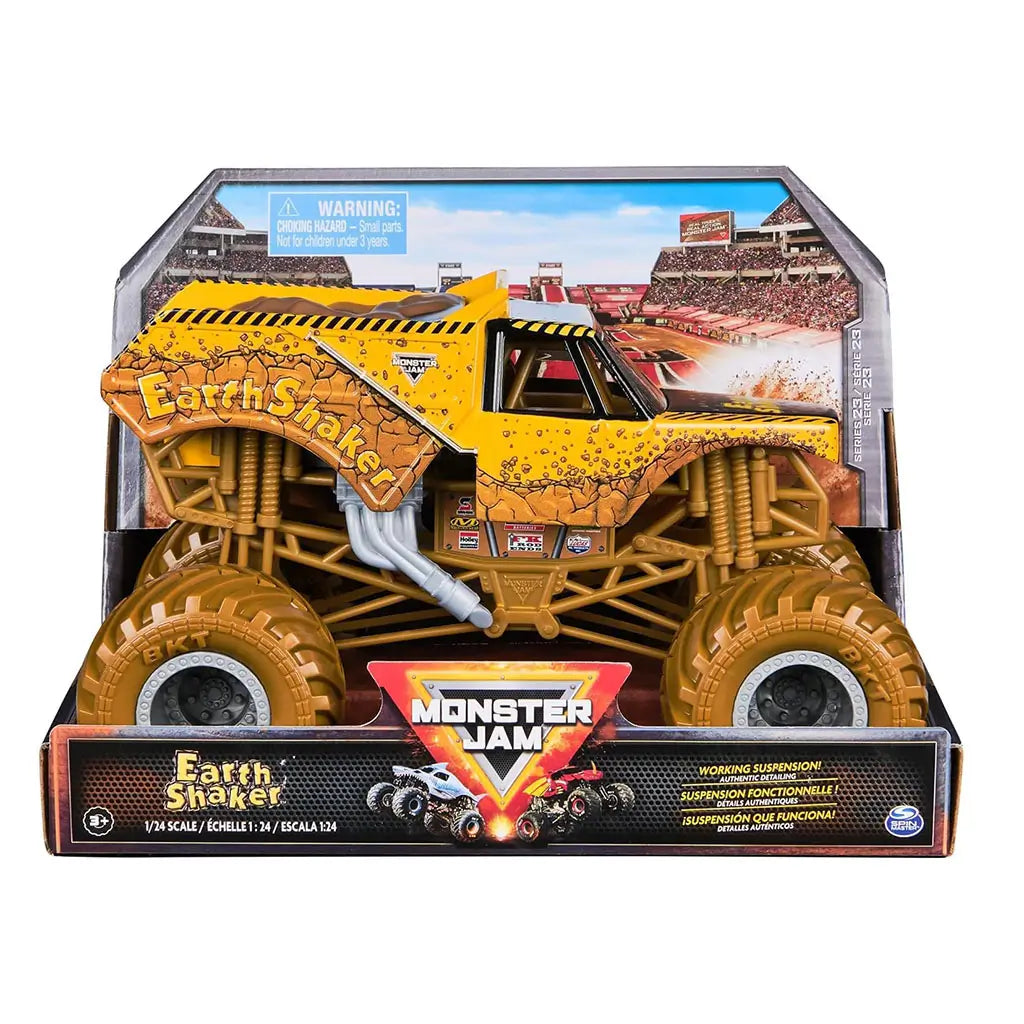 Packaged Monster Jam Earth Shaker diecast truck in 1:24 scale shows cracked yellow design, oversized tires, and branding in a stadium backdrop box with working suspension label.