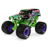 Angled view of the Monster Jam Grave Digger diecast truck highlights vivid green frame, spooky graveyard artwork, chrome exhaust pipes, and large black tires with purple hubs in a dynamic studio shot.