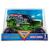 Monster Jam Grave Digger 1:24 scale diecast truck packaging displays the iconic green chassis, black haunted graphics, and large black BKT tires with purple accents inside a clear stadium-themed box.