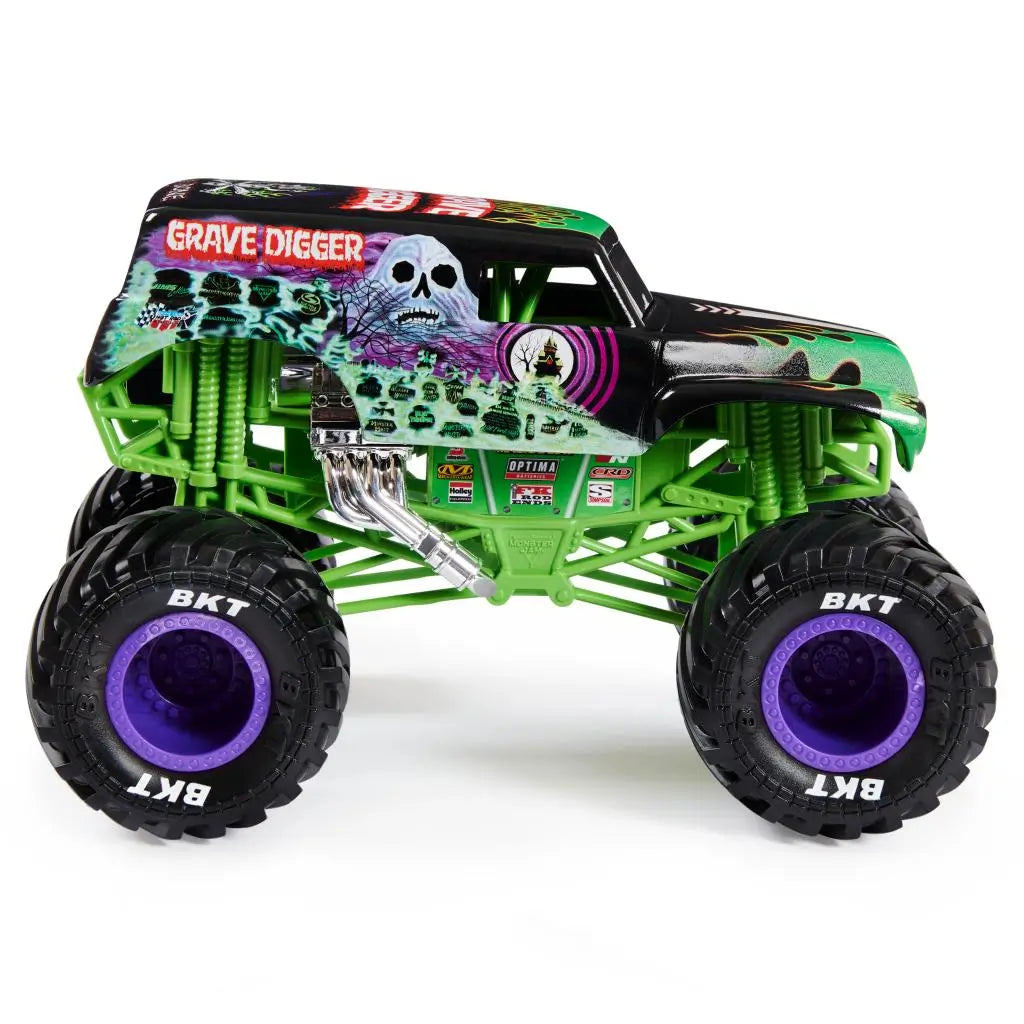 Side view of the Monster Jam Grave Digger diecast truck reveals green suspension frame, detailed graveyard graphics, chrome exhaust, and oversized black BKT tires with purple hubs on a white backdrop.