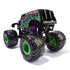 Rear angled view of Monster Jam Grave Digger 1:24 scale diecast truck, showing oversized black tires with green hubs, purple exhaust pipes, and ghostly artwork.