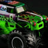 Monster Jam Grave Digger 1:64 scale diecast truck in green and black with flame decals, red headlights, and ghostly skull graphics, shown close-up highlighting tire details.