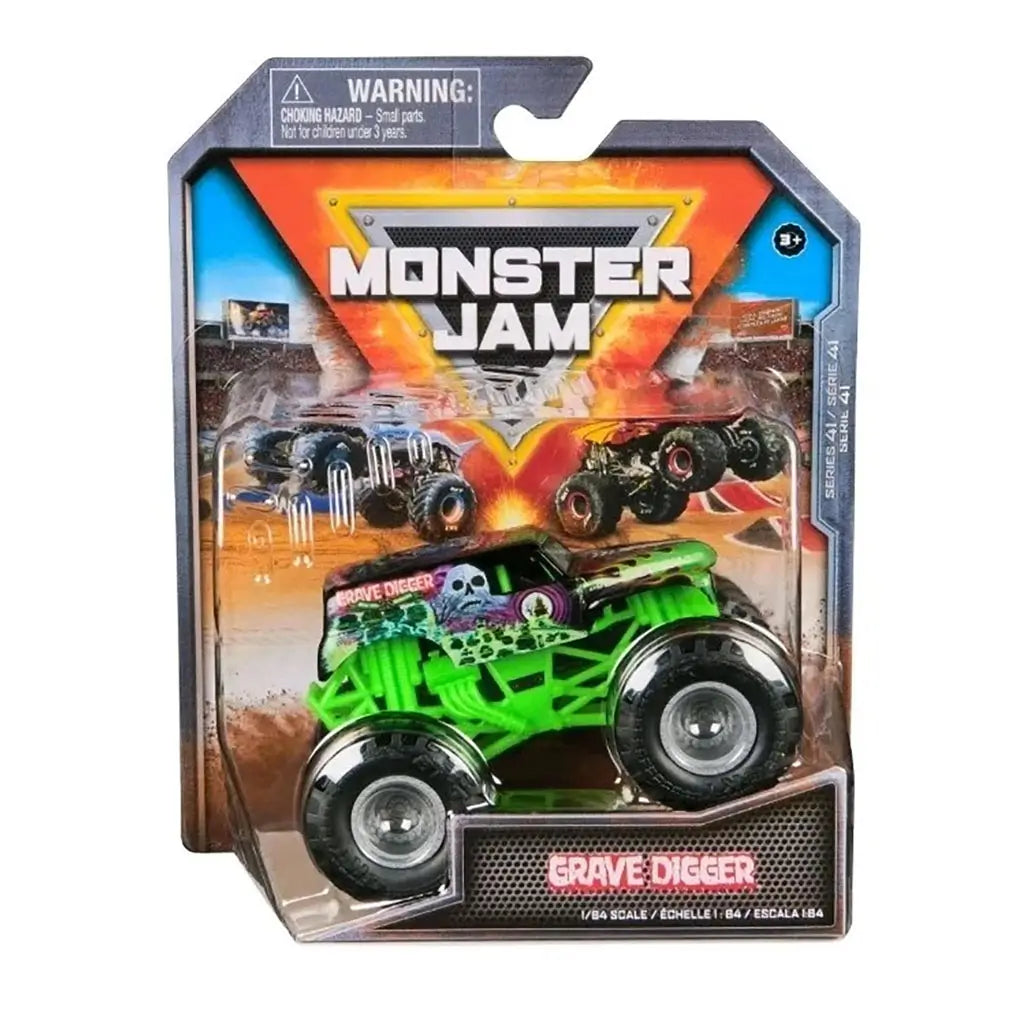 Monster Jam Grave Digger 1:64 diecast truck in retail package, showcasing black and green design with flaming hood, skull artwork, and event-themed background graphics.