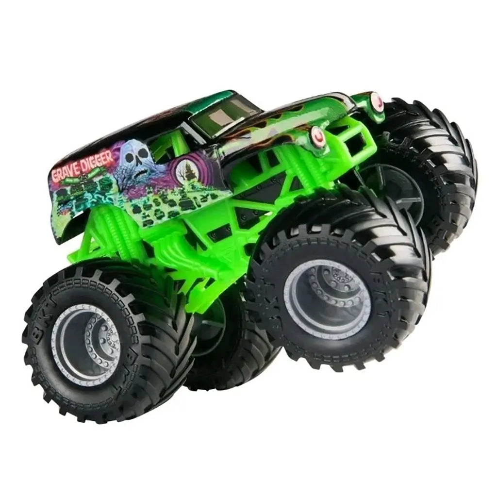 Diecast Monster Jam Grave Digger truck at side angle, showing bright green chassis, oversized black tread tires, and detailed ghost and skull artwork along the body.