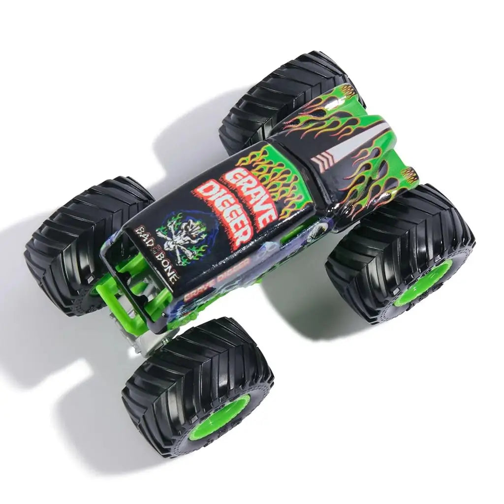 Monster Jam Grave Digger Legacy 1:64 scale toy truck top view showing black roof with green flames, Grave Digger logo, skeleton emblem, and large rugged wheels below.