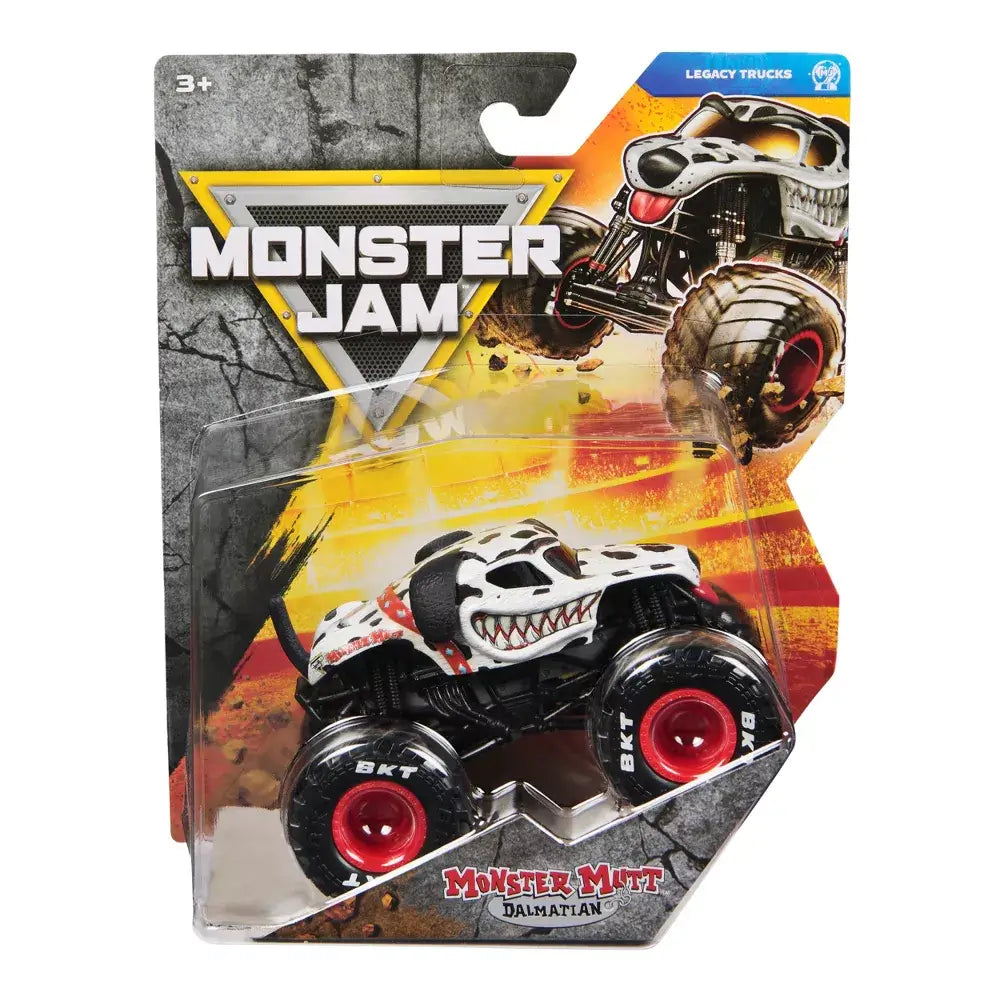 Monster Jam toy truck packaging in gray, yellow, and black cardboard with plastic blister casing, featuring Monster Mutt Dalmatian die-cast truck, displayed against a rugged graphic background.
