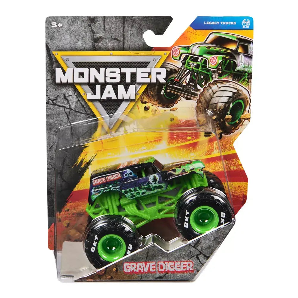 Monster Jam Grave Digger toy truck in black and green painted metal and plastic with flame and skull graphics, boxy body and oversized rubber tires with green rims, sealed in retail blister packaging with action artwork background.