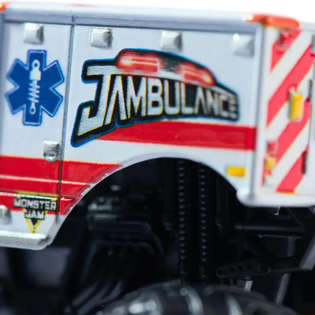 Monster Jam Jambulance Everyday Hero 1:64 scale toy truck close-up view highlighting side graphics with ambulance theme, red stripes, blue star emblem, and bold lettering.