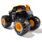 Angled rear view of Monster Jam JCB Digatron 1:64 scale diecast truck, with orange roof, black body, silver detailing, and large BKT tires with yellow hubs.