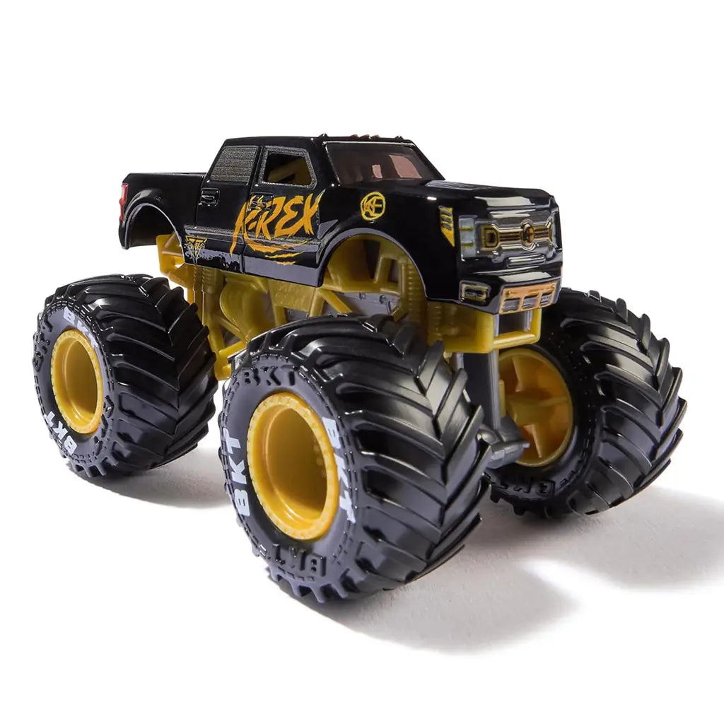 Angled view of Monster Jam Kane Brown K-Rex diecast truck at 1:64 scale, with sleek black cab, orange accents, gold undercarriage, and massive BKT tires.