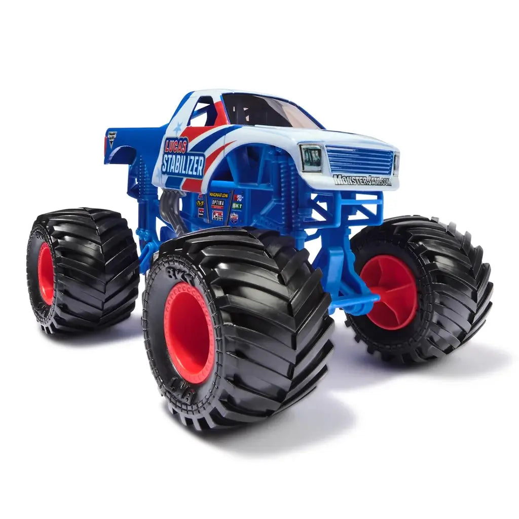 Monster Jam Lucas Stabilizer diecast truck features blue and white body with bold red accents, detailed sponsor decals, chrome exhaust pipes, and oversized black BKT tires on a white studio background.