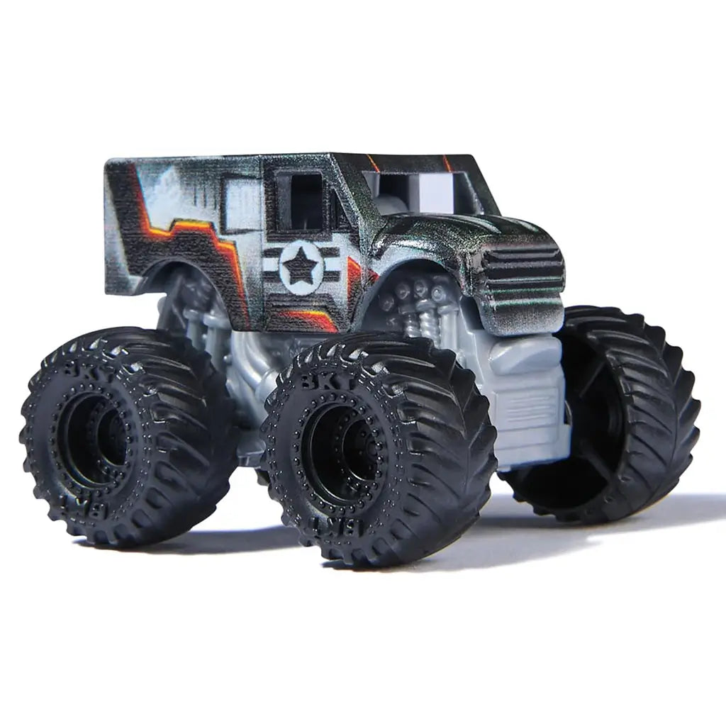 Close-up of Monster Jam Marvel Thor mini monster truck with gray body, red hammer detail, and oversized black wheels, part of 1:87 scale three-pack set.