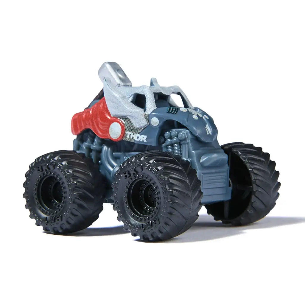 Marvel Thor mini Monster Jam truck in 1:87 scale, gray armored body with red cape accents and silver hammer mounted on top, angled view highlighting hero-inspired design.