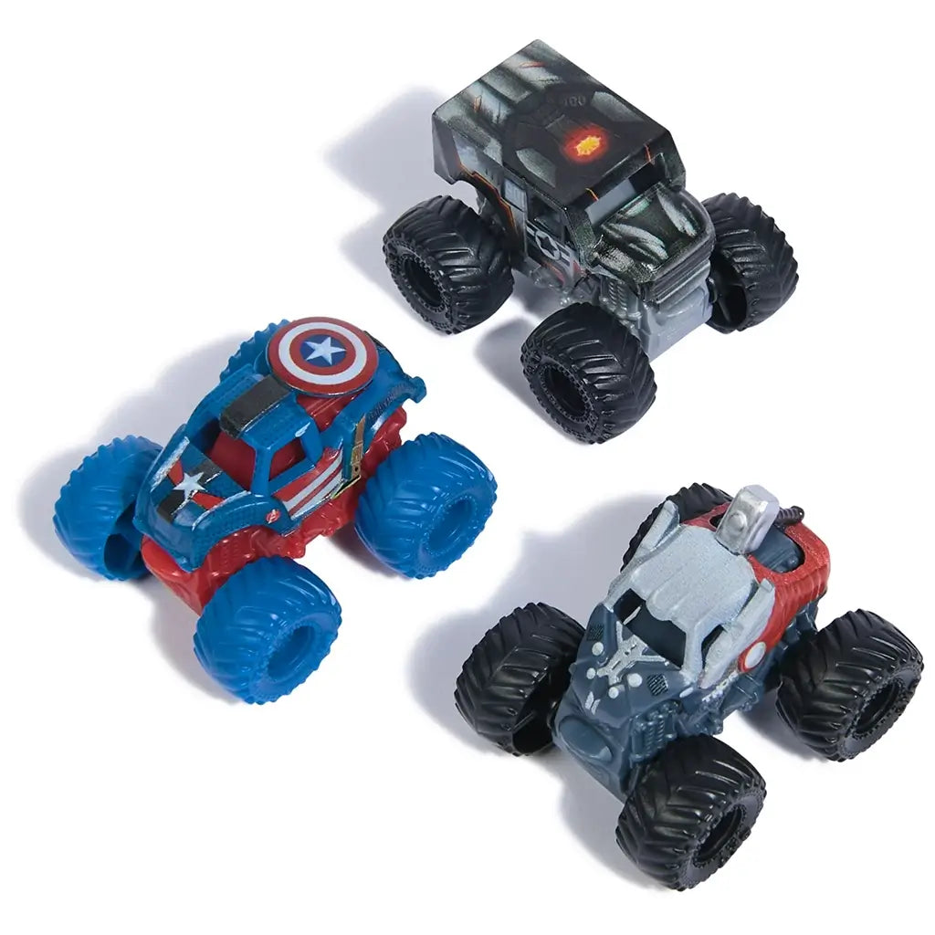 Three Marvel Monster Jam 1:87 scale trucks—Thor, Captain America, and War Machine—arranged together, showing colorful hero-themed detailing, wheels, and compact size.
