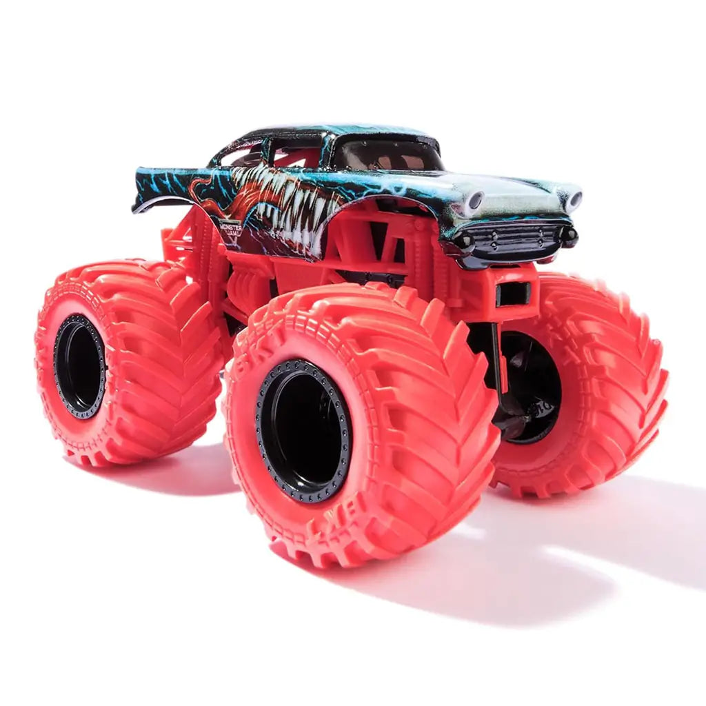 Front angled shot of Monster Jam Marvel Venom truck shows chrome-detailed grille, sharp fang artwork, and oversized textured red tires on a bold lifted chassis design.
