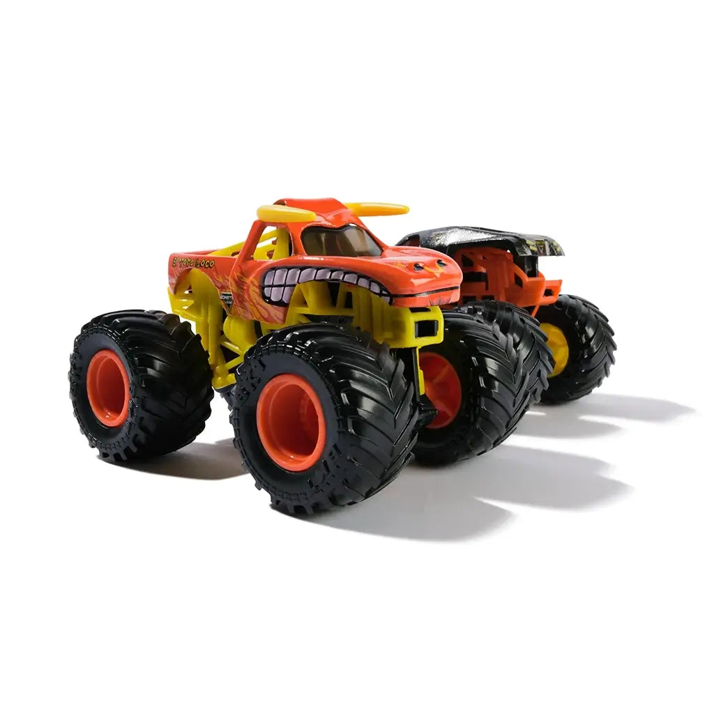 Monster Jam El Toro Loco truck in orange and yellow textured plastic with bull horn details and large black rubber tires designed for stunt play shown in a clean angled studio setting.
