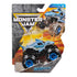 Monster Jam Megalodon toy truck in blue molded plastic shaped like a shark with textured body, oversized rubber tires, and black chassis, displayed in branded retail packaging with action graphics background.
