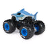 Monster Jam Megalodon toy truck rear angled view in blue shark-shaped plastic body with textured fins, oversized rubber tires, detailed black chassis and suspension, shown on a white background.