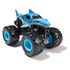 Blue Monster Jam Megalodon toy truck with smooth shark-shaped plastic body, large black rubber tires with bright blue hubs, and detailed gill and tooth accents, displayed on a clean white background.