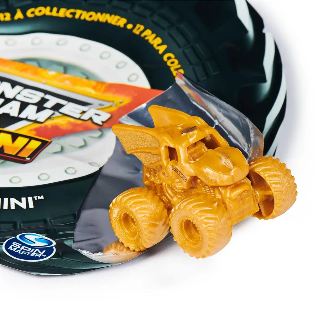 Monster Jam Dragon mini truck in metallic gold plastic with sculpted dragon wings and scales, fantasy creature-shaped body on oversized gold rubber tires, displayed beside packaging on white background.