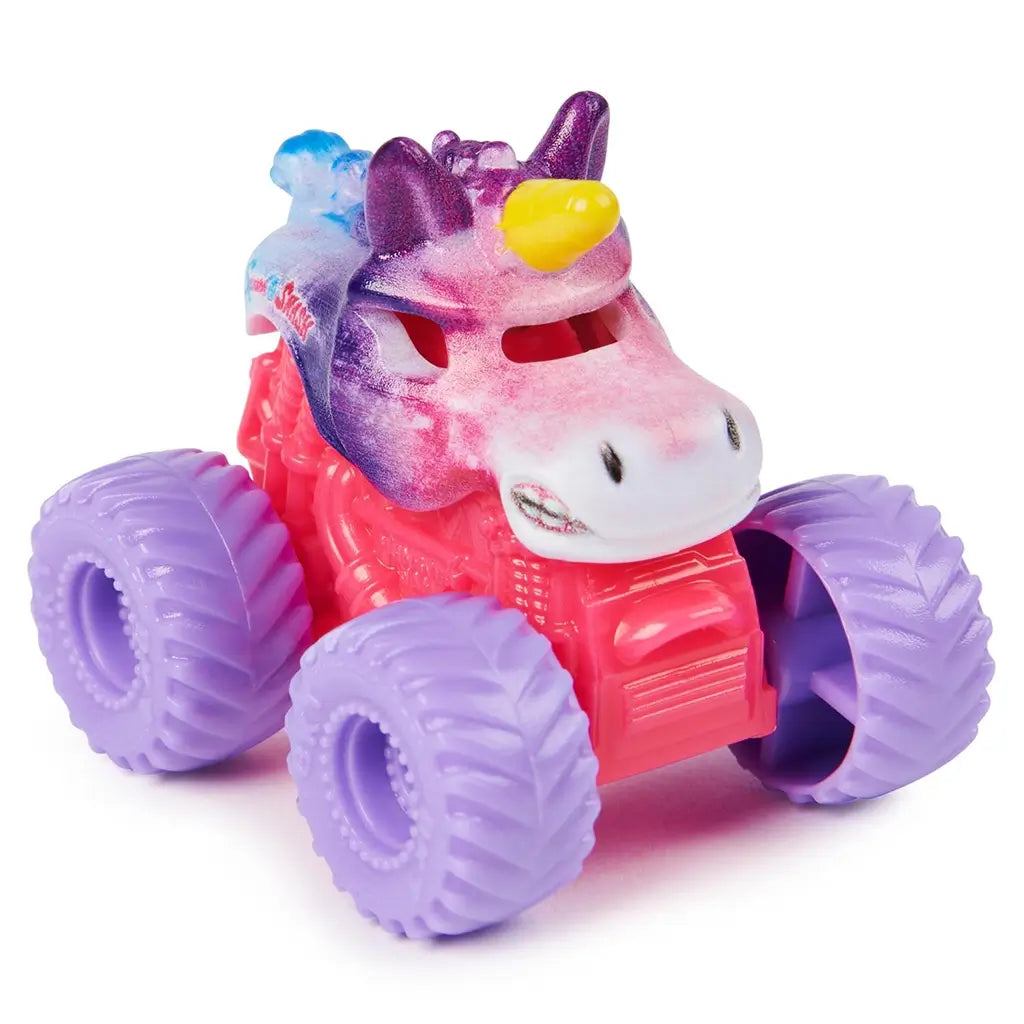 Monster Jam Sparkle Smash unicorn mini truck in pink, purple, and white glitter plastic with horn detail, rounded animal-shaped body on large lavender rubber tires, shown on a bright white studio background.