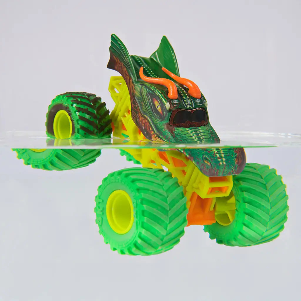 Monster Jam Dragon toy truck in bright green and yellow plastic with textured scales and horn details, oversized tires, partially submerged in water to demonstrate color change feature on a clean minimal background