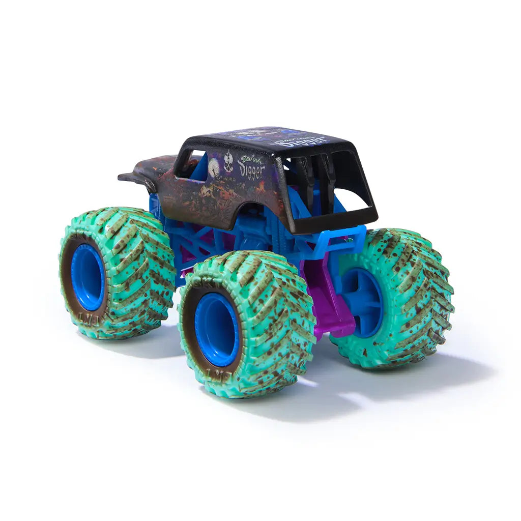 Monster Jam Son-uva Digger toy truck in black plastic with mud texture, oversized green tires and blue rims, rear angled view showing rugged monster truck form, isolated on a clean white background