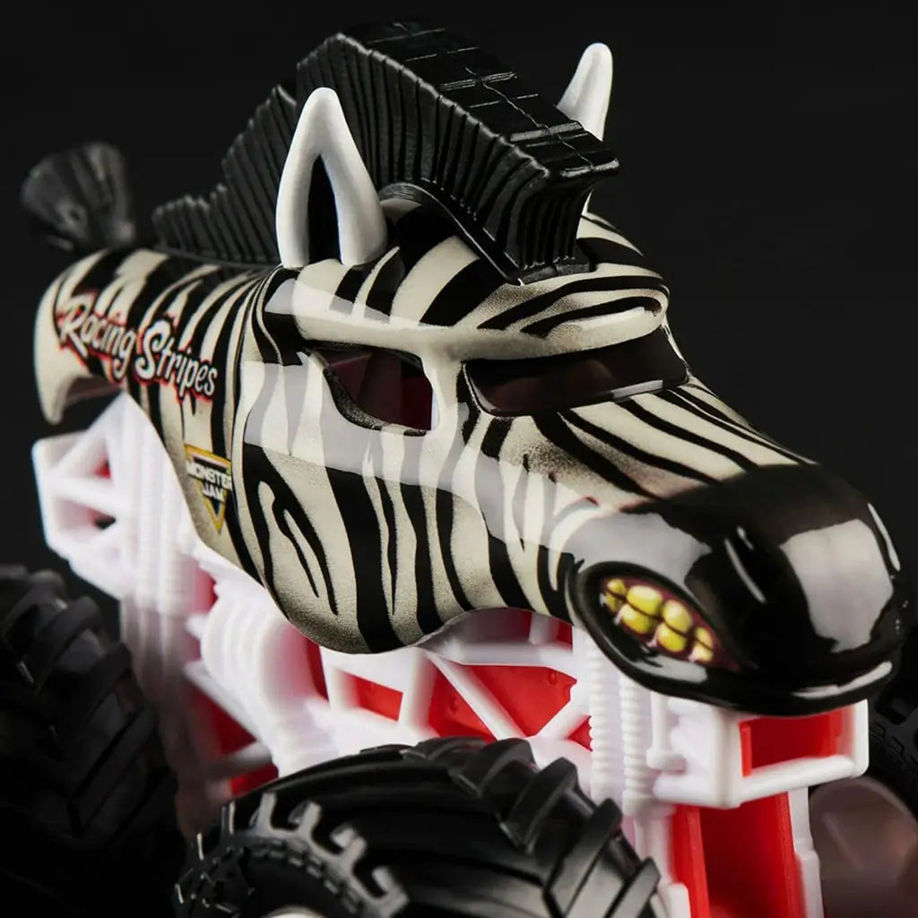 Close-up of Monster Jam Racing Stripes 1:64 diecast truck, styled like a zebra with black stripes, pointed ears, fierce yellow eyes, and bold white frame.