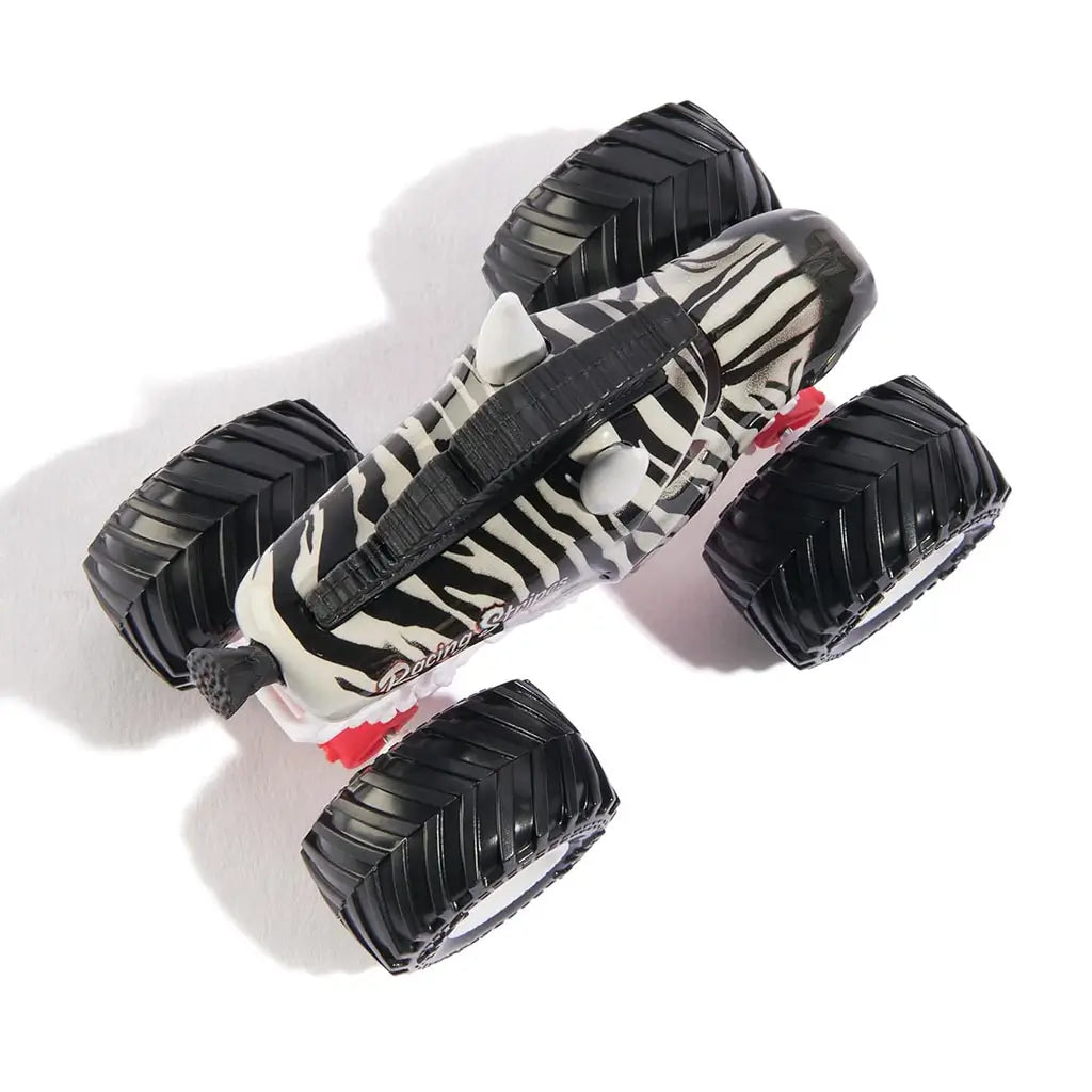 Top view of Monster Jam Racing Stripes 1:64 diecast truck, highlighting zebra stripe pattern, sculpted mane, and four rugged black wheels with white hubs.