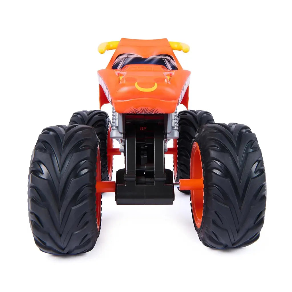 Monster Jam El Toro Loco Rev ’n Roar monster truck in orange plastic with bull face front, yellow horns, flame graphics, and massive treaded tires, shown head-on to emphasize aggressive styling and toy truck proportions.
