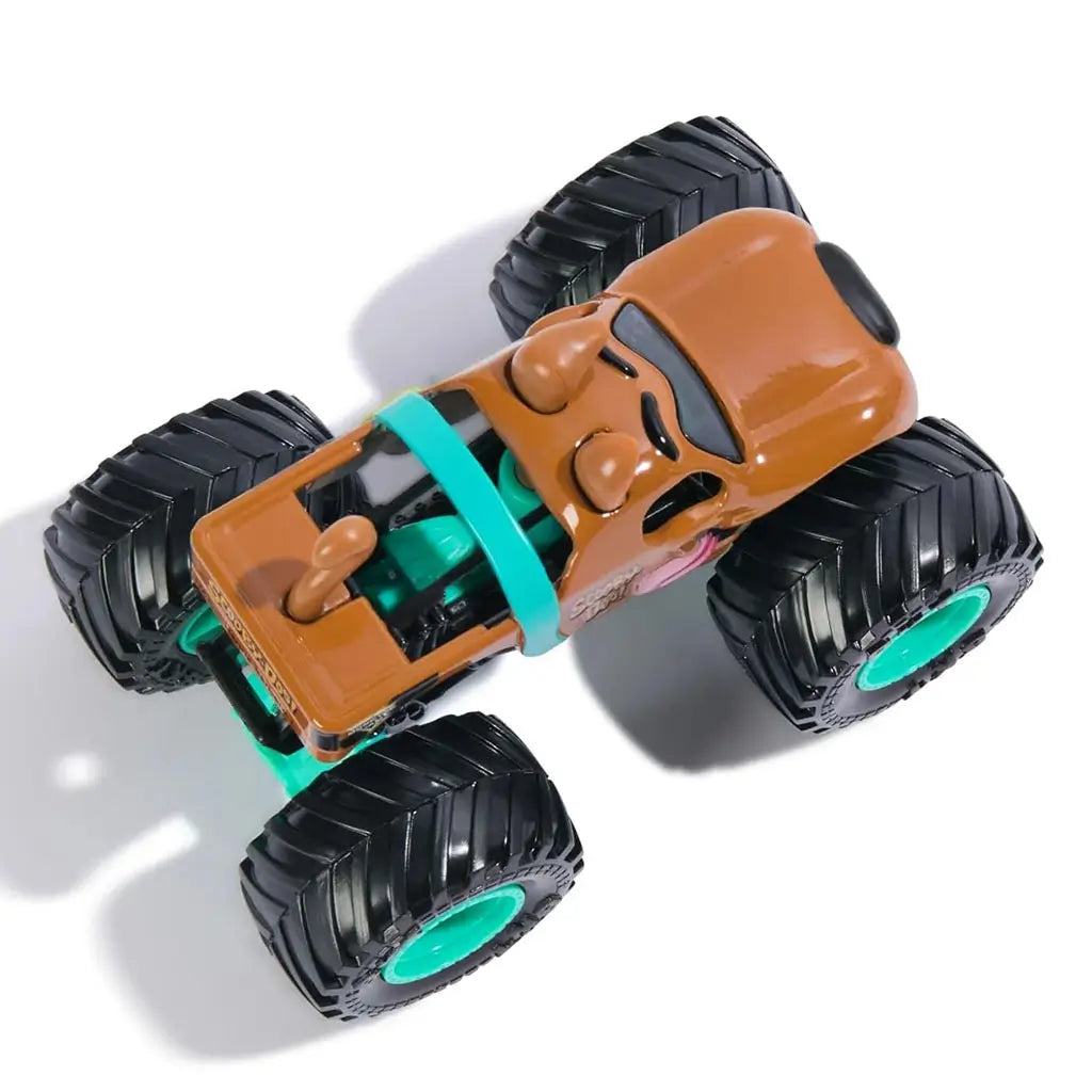 Top view of Monster Jam Scooby-Doo diecast truck featuring molded dog ears, teal roll cage, tongue graphic, chunky black wheels, and teal hubs emphasizing cartoon-inspired look.