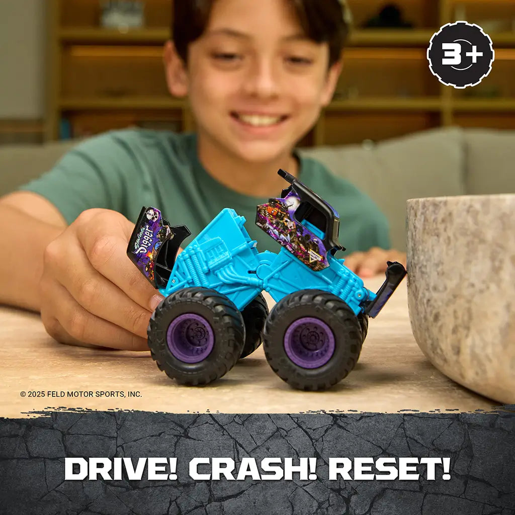 Monster Jam Son Uva Digger toy truck in teal blue plastic with black body and purple wheels, oversized monster truck shape, shown mid-play with a child demonstrating crash and reset feature indoors.