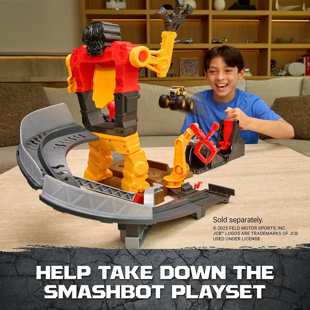 Monster Jam Smash Bash playset in red, yellow, and gray plastic with mechanical robot structure, large interactive crash arena design, shown with a child launching a toy truck in a living room setting.