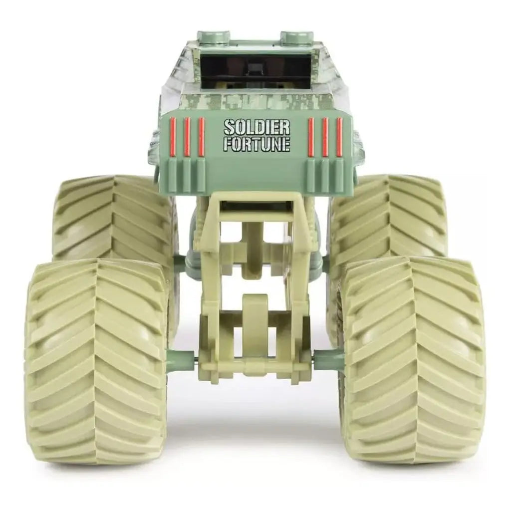 Rear view of Monster Jam Soldier Fortune diecast truck highlights tan camouflage body, large beige treaded wheels, angular back design, and bold Soldier Fortune lettering in white.