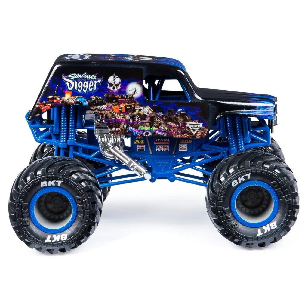 Side view of the Monster Jam Son-Uva Digger diecast truck reveals black flame-graphic body, bright blue suspension frame, chrome exhaust pipes, and oversized BKT tires against a white studio backdrop.