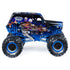 Side view of the Monster Jam Son-Uva Digger diecast truck reveals black flame-graphic body, bright blue suspension frame, chrome exhaust pipes, and oversized BKT tires against a white studio backdrop.