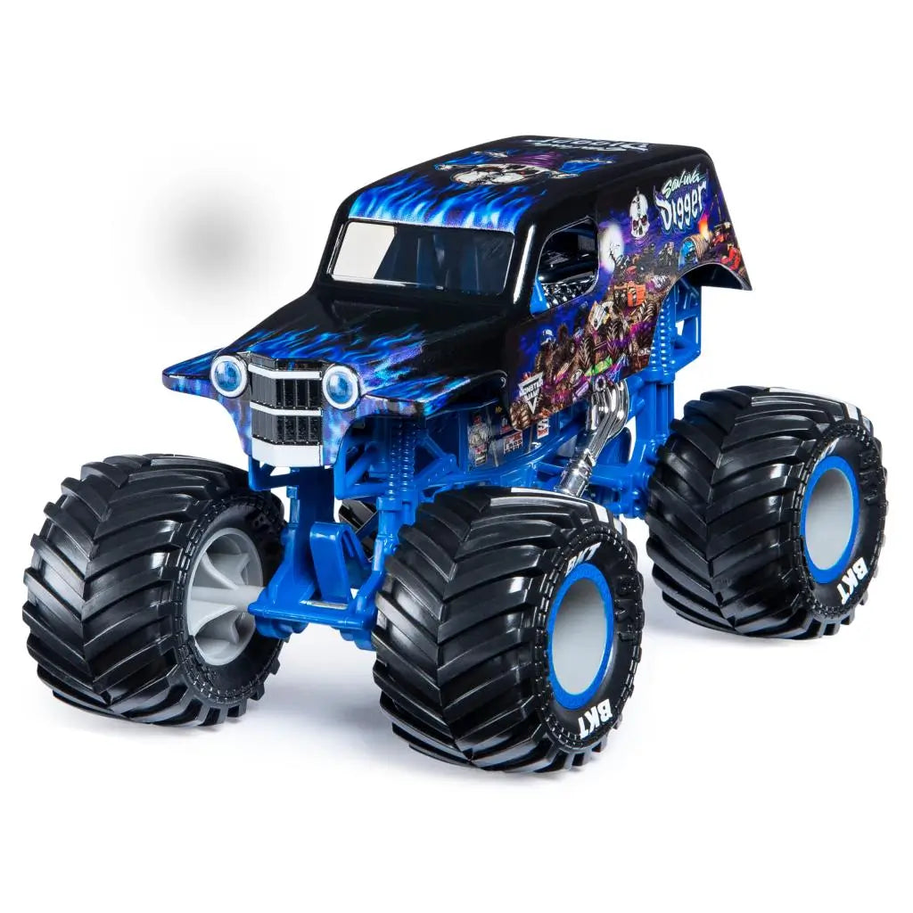 Monster Jam Son-Uva Digger diecast truck displays black body with blue flame graphics, rugged metal frame, and oversized BKT tires, emphasizing detailed construction on a clean white studio background.