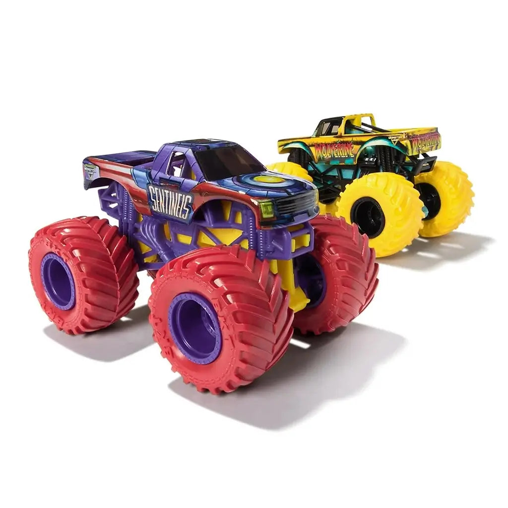 Monster Jam Sentinels toy truck in purple and red painted metal body with futuristic graphics, oversized rubber tires, lifted suspension frame, detailed pickup shape, displayed on a white background.