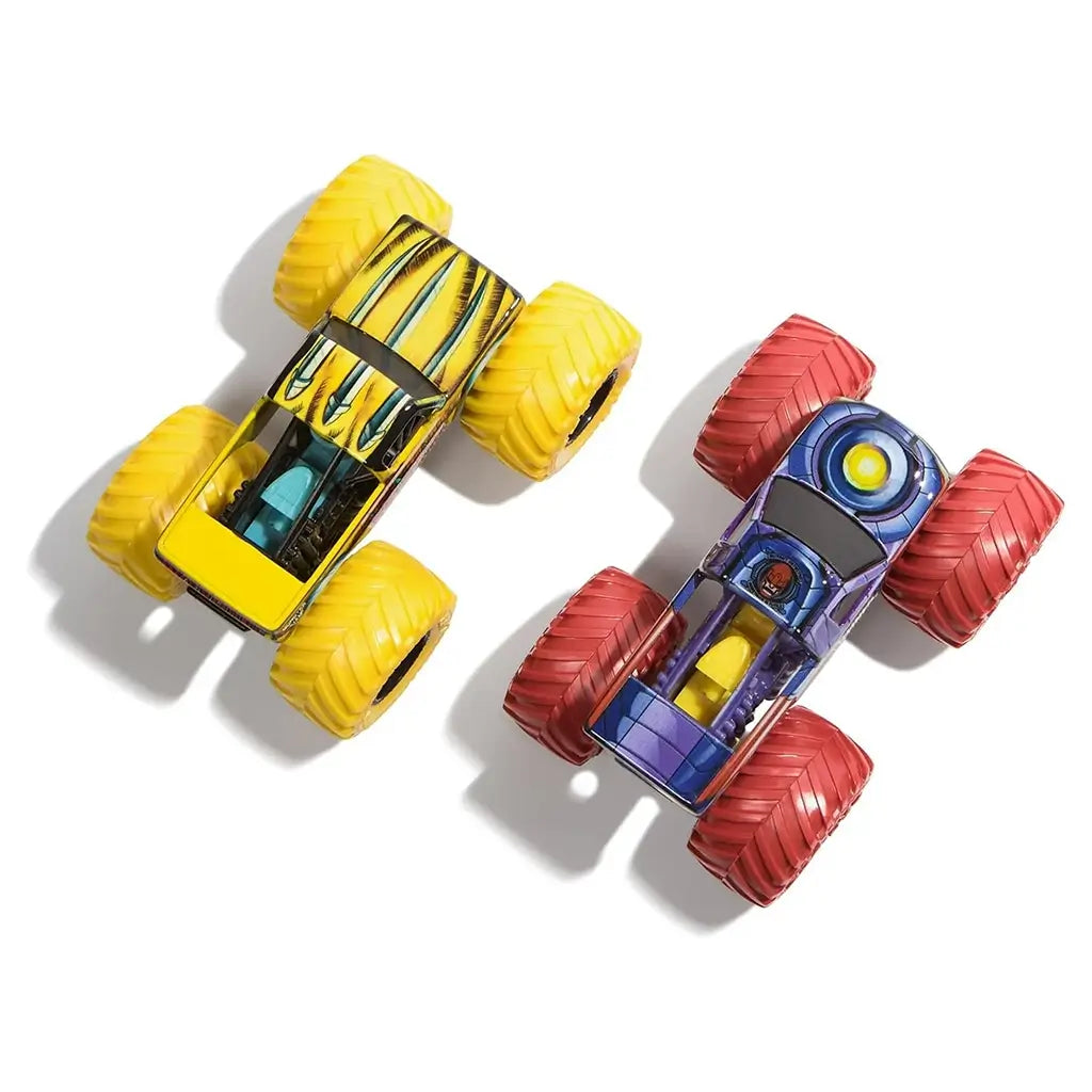 Monster Jam Wolverine and Sentinels trucks top view in yellow and purple painted metal bodies with oversized rubber tires, detailed chassis and graphics, arranged on a clean white background.