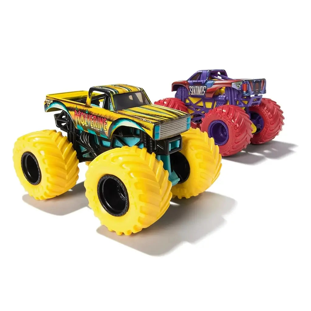 Monster Jam Wolverine toy truck in yellow and teal painted metal with black stripe accents, oversized rubber tires, lifted suspension frame, detailed pickup body, displayed on a clean white background.