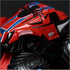 Monster Jam Spider-Man truck close-up showing red glossy metal body with black web graphics and blue accents, oversized textured rubber tires, detailed design on a dark studio background.