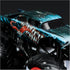 Monster Jam Venom truck close-up showing black and teal glossy metal body with sharp teeth graphics, detailed texture, oversized rubber tires, and suspension parts on a dark background.