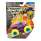 Monster Jam Zombie toy truck in neon yellow, purple, and pink molded plastic with textured zombie graphics, oversized rubber tires, and blue hubs, displayed in branded retail packaging with action artwork background.