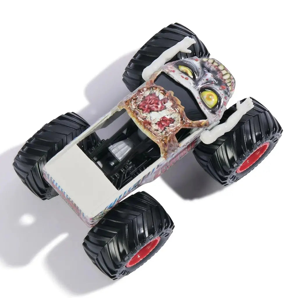 Monster Jam Zombie toy truck viewed from top, featuring white body with gory zombie graphics, large black textured wheels, red rims, and raised plastic zombie arms for dramatic effect.