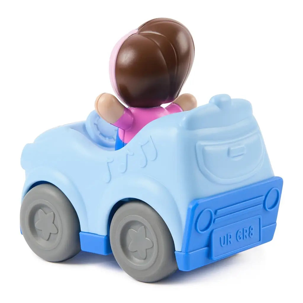 Ms. Rachel 1-2-3 Roll vehicle toddler toy in soft blue plastic with gray wheels and seated girl figure, rounded rear car shape with molded music notes, pull-back learning car shown from a back angled view on a white background.