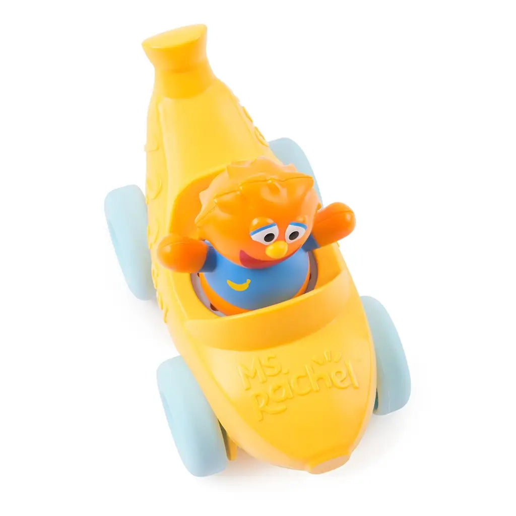 Ms. Rachel Herbie’s 1-2-3 Roll vehicle toddler toy in glossy yellow plastic with light blue wheels, curved banana-shaped body and smiling orange character, pull-back learning car viewed from above on a white background.